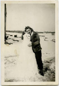 Vintage photo of a woman hugging a snowman