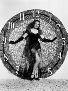 Vintage photo of a woman standing against a large clock
