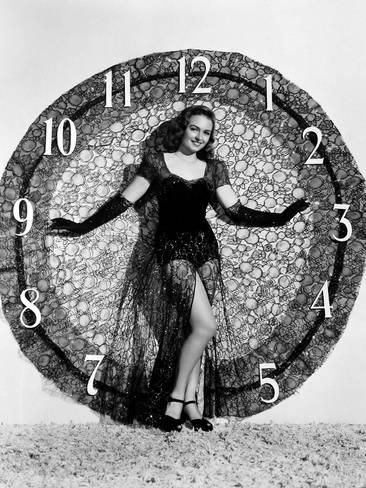 Vintage photo of a woman standing against a large clock