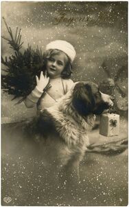 Vintage photo of a little girl holding pine branches behind a saint bernard