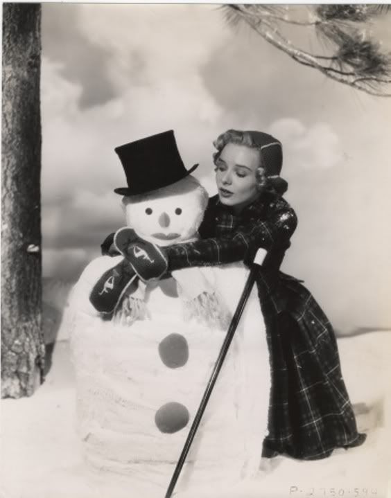 Woman with arms around a snowman
