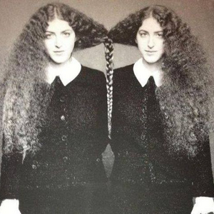 Vintage photo of twin girls with their hair braided together