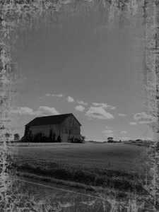Black and white photo of a farm house from a distance