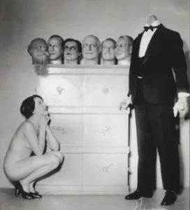 Nude woman looking at a headless mannequin