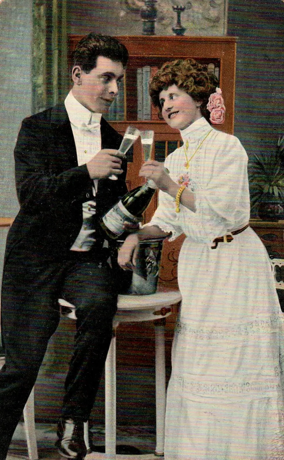 Vintage postcard of a well-dressed man and woman toasting two glasses of champagne.