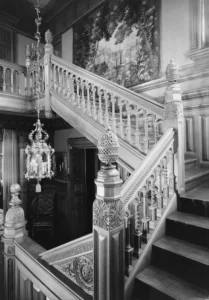An ornate staircase in a mansion