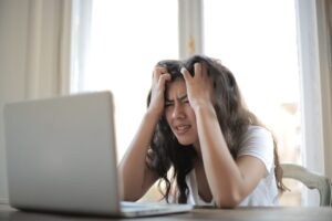 Frustrated woman looking at a computer