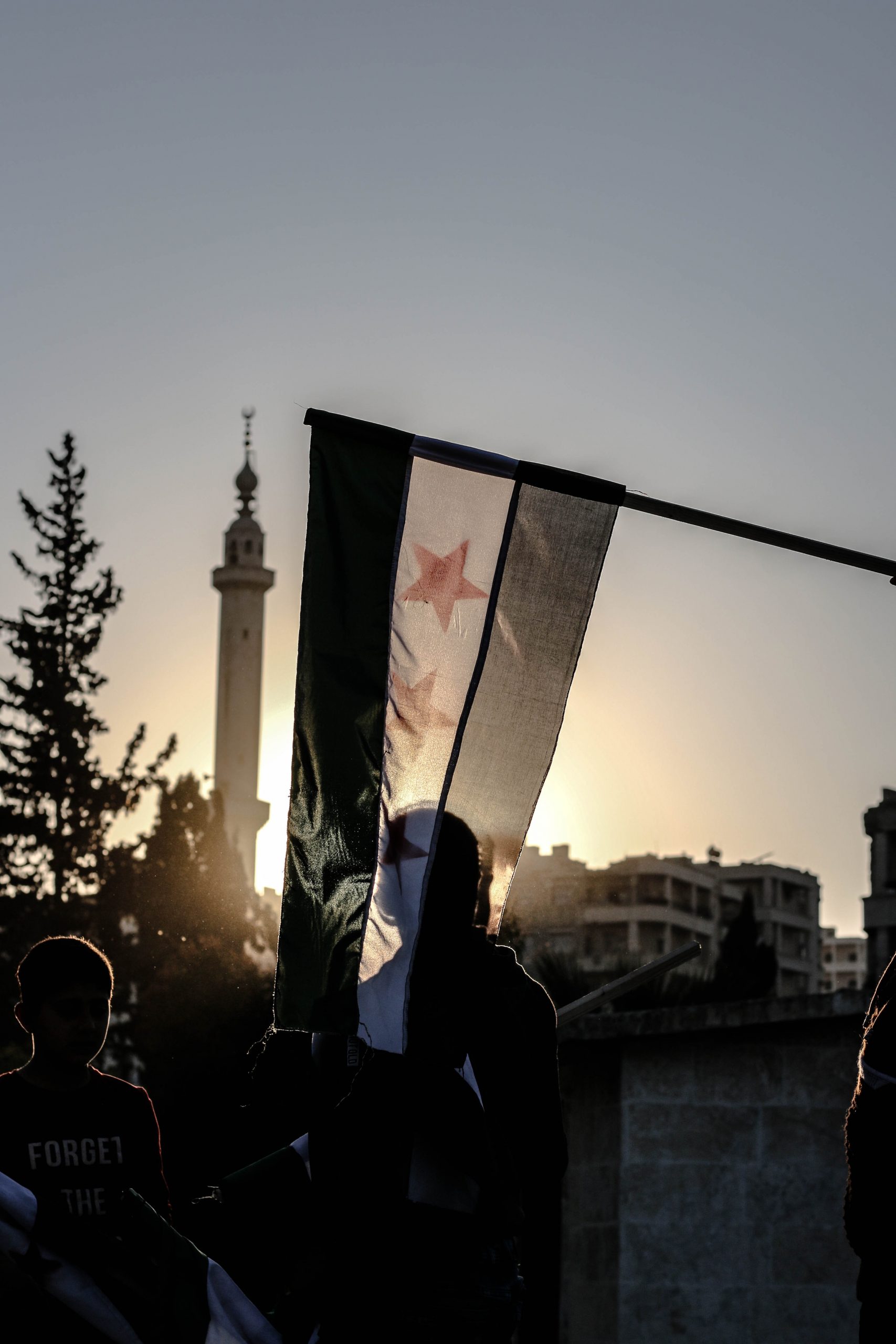 Men in a City and Syrian Flag