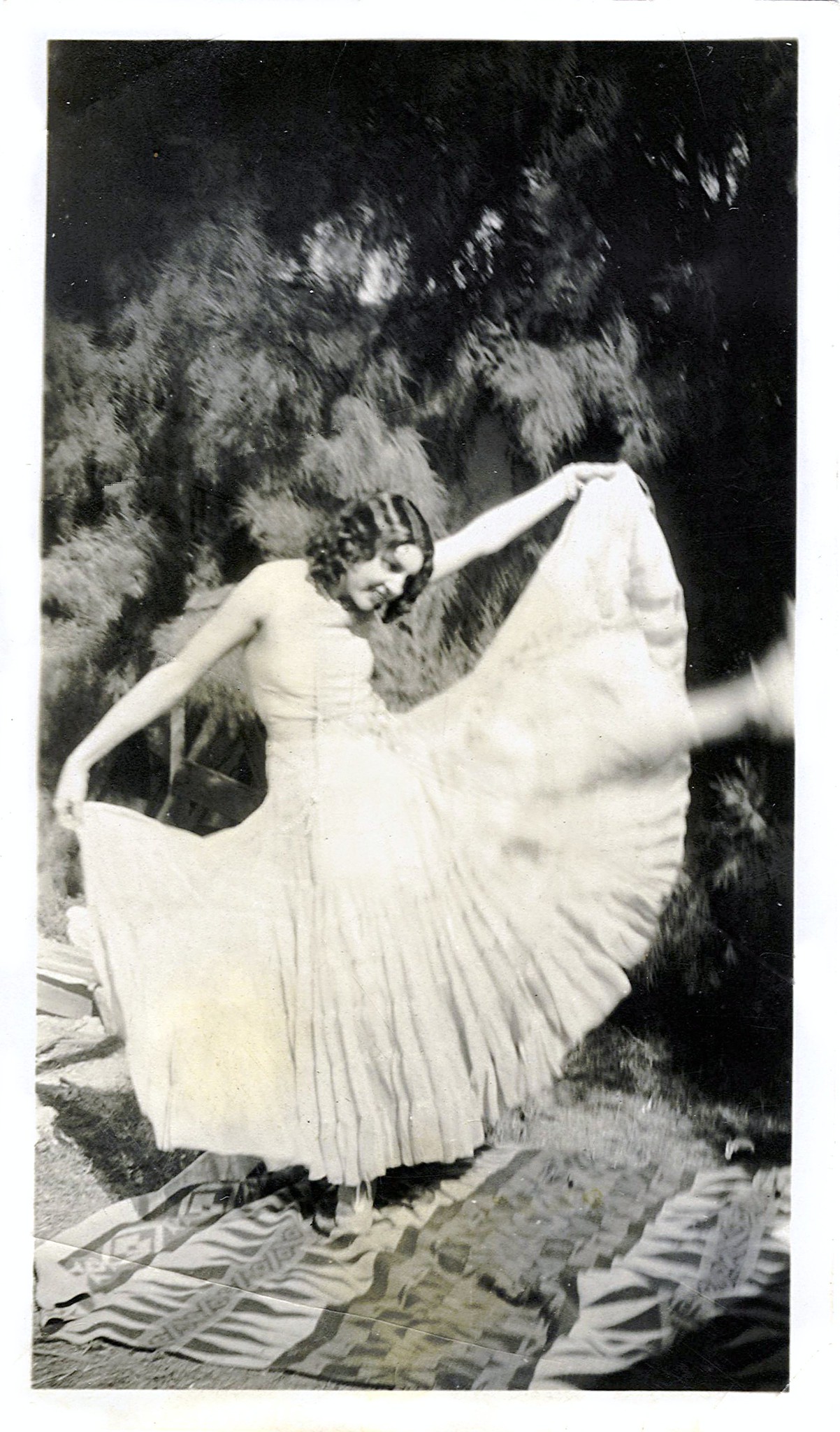 Vintage photo of a woman in a white dressing dancing