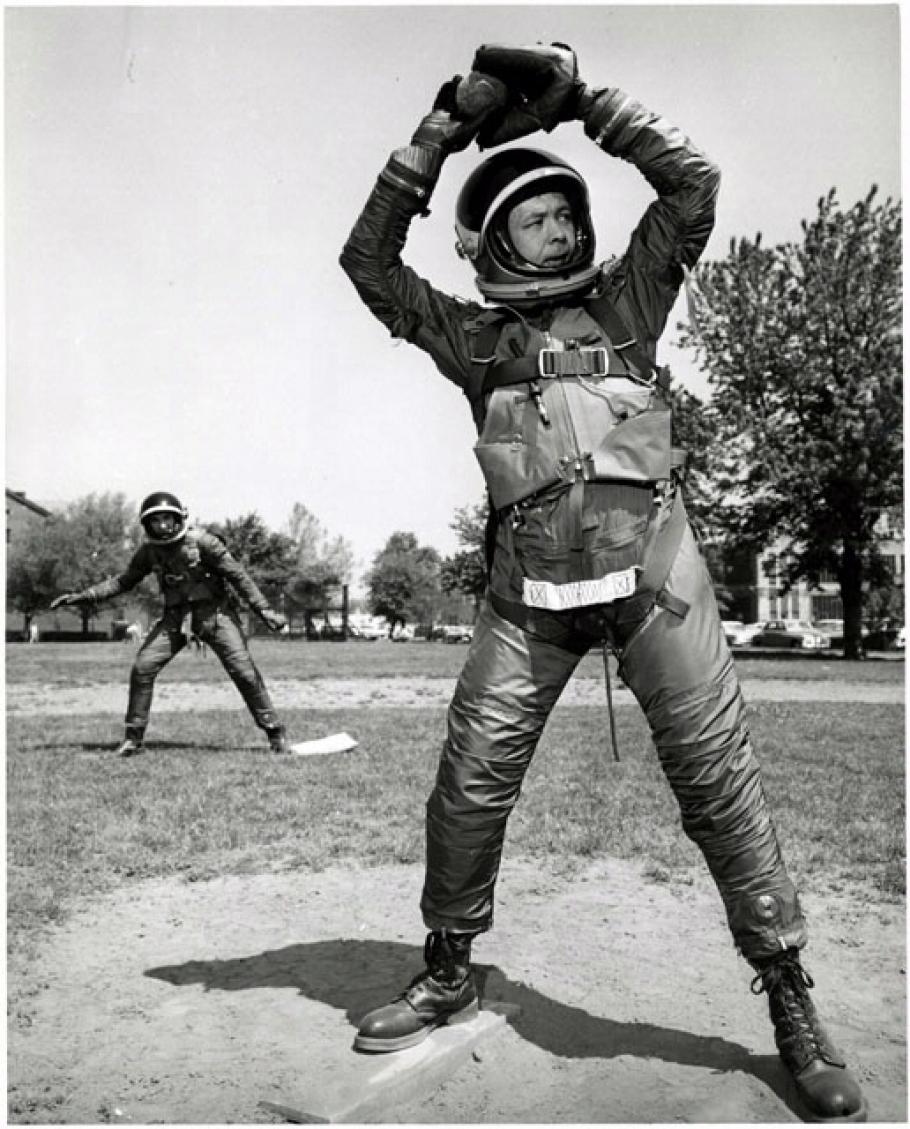 At the U.S. Naval Air Material Center in Philadelphia, a player swings a baseball bat in a B.F. Goodrich Mark IV spacesuit.