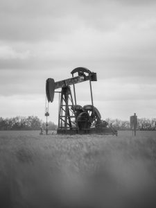 black and white oil pumpjack in kansas field