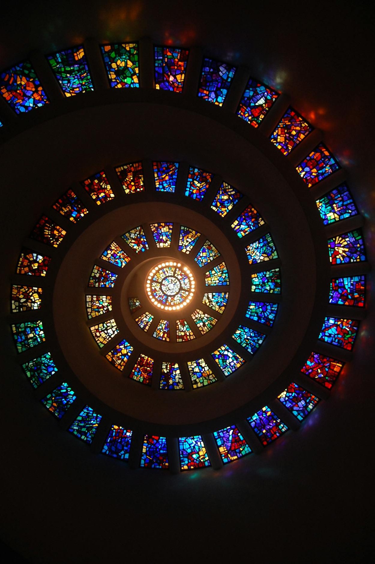 worms eye view of spiral stained glass decors through the roof